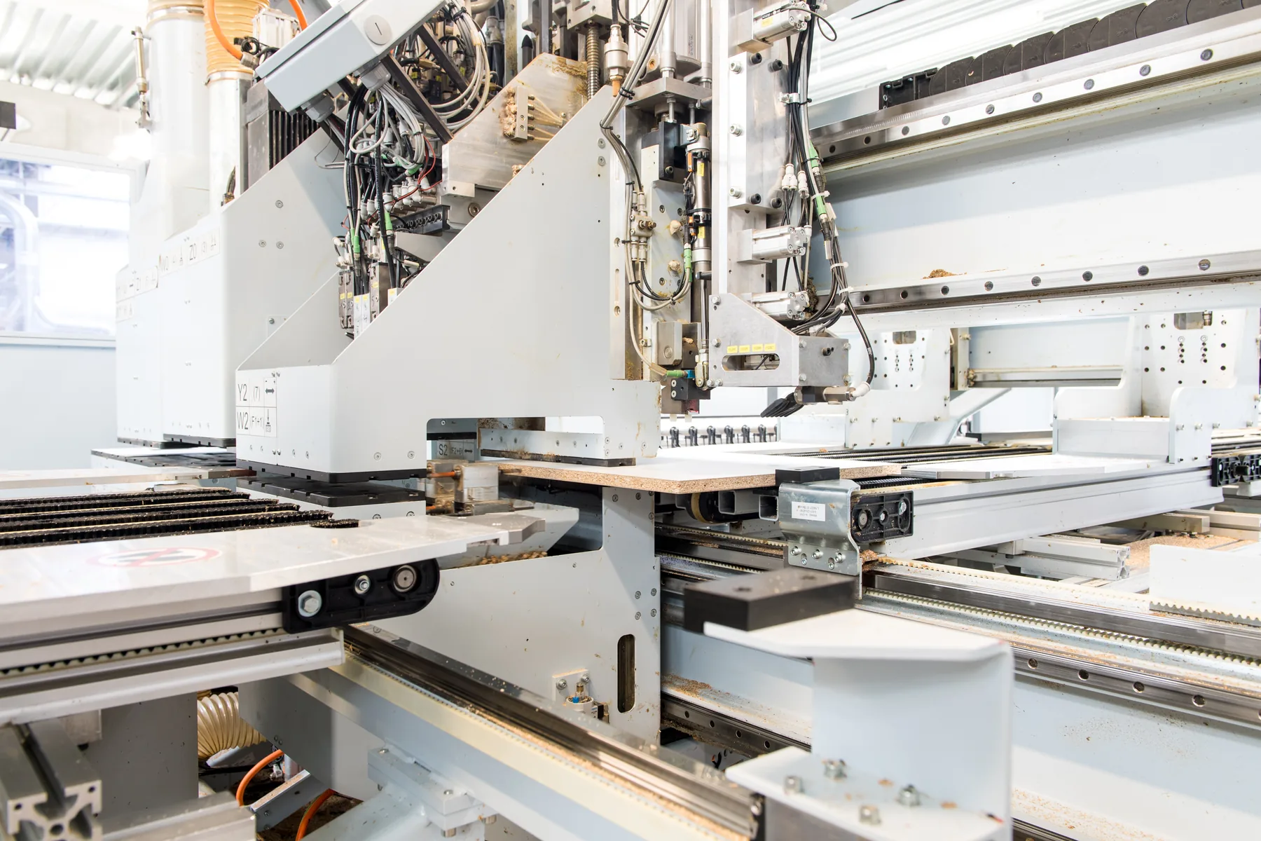 CNC drilling and milling head above a panel part