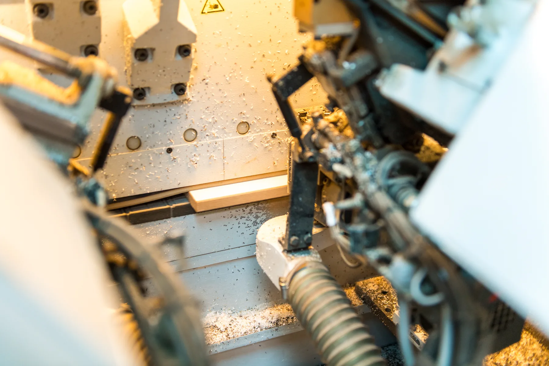 Close-up of a CNC machine processing panel material